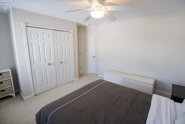 carpeted bedroom with a closet and ceiling fan