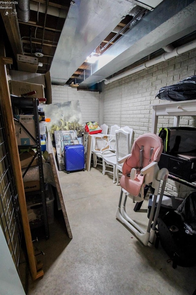 basement featuring brick wall