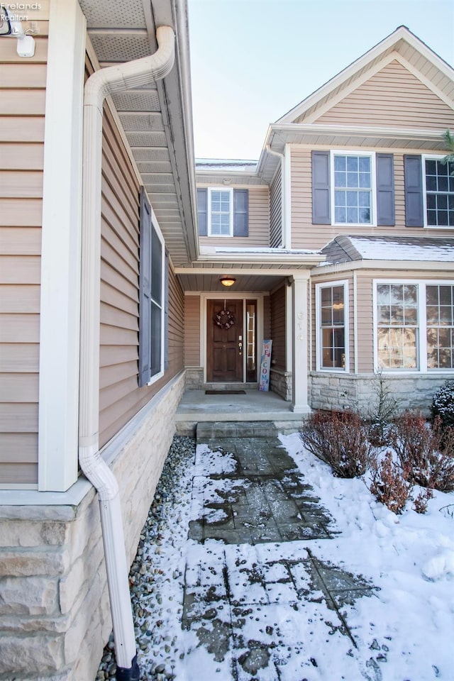 view of snow covered property entrance