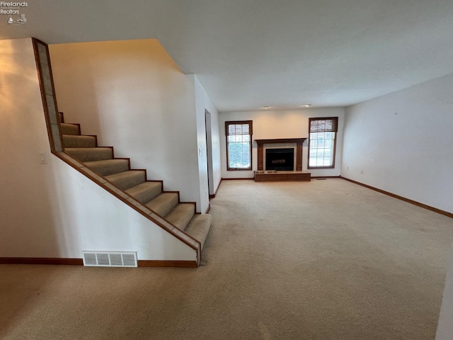 unfurnished living room featuring carpet flooring