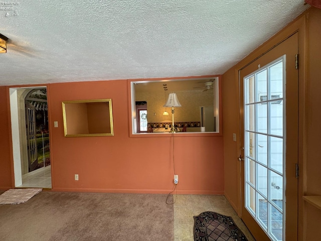 unfurnished room with a textured ceiling