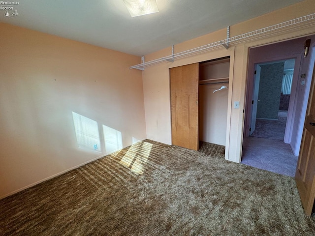 unfurnished bedroom featuring a closet and carpet floors