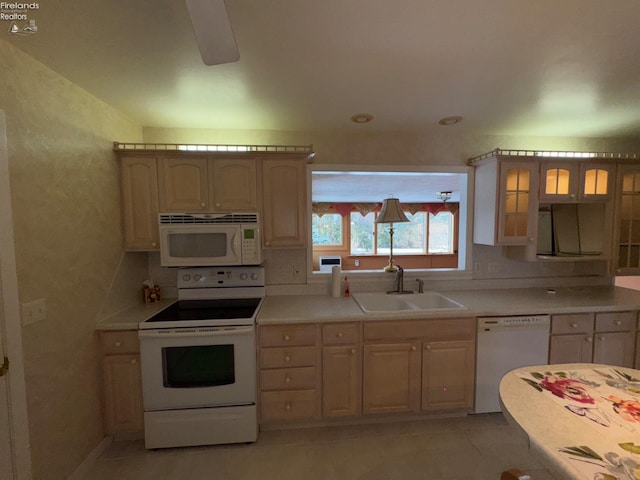 kitchen with light brown cabinets, ceiling fan, sink, light tile patterned floors, and white appliances