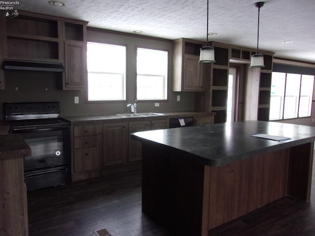 kitchen featuring a kitchen island, pendant lighting, sink, black appliances, and a textured ceiling