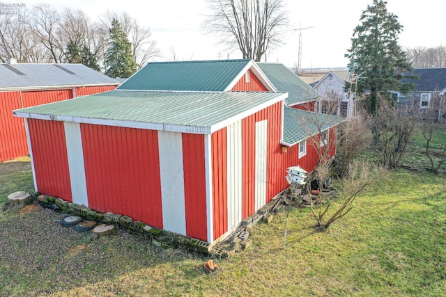 view of outbuilding featuring a yard