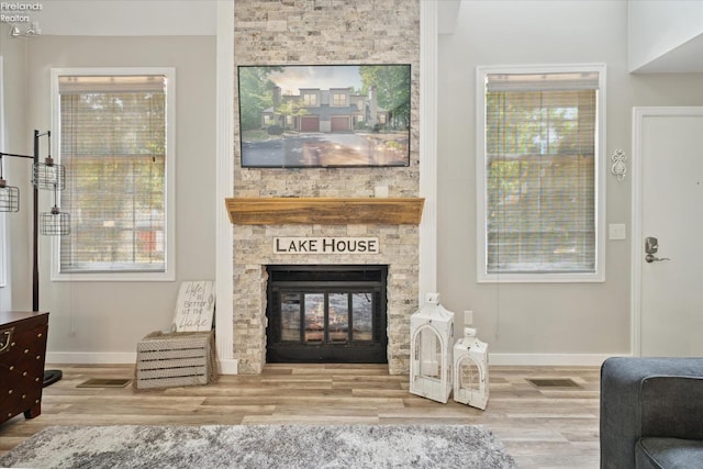 sitting room featuring a fireplace and wood-type flooring