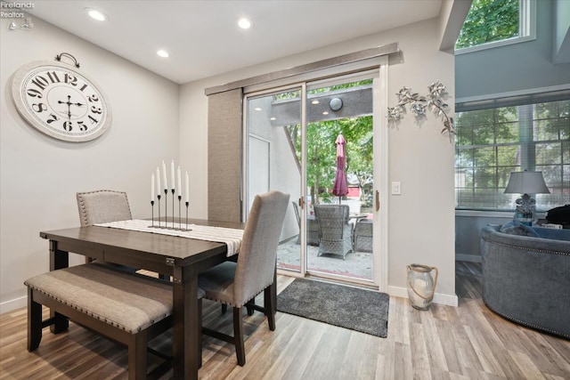 dining room with a wealth of natural light and light hardwood / wood-style flooring