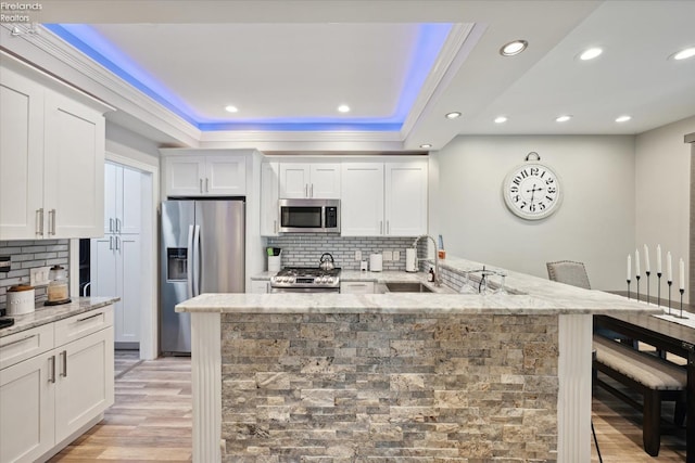 kitchen featuring white cabinetry, sink, decorative backsplash, and appliances with stainless steel finishes