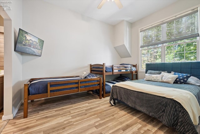 bedroom with ceiling fan and light wood-type flooring