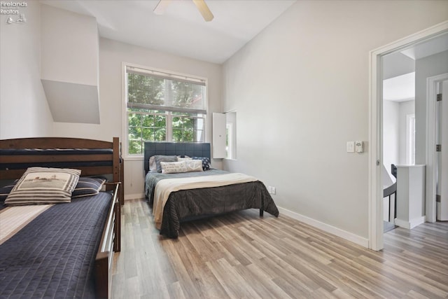 bedroom featuring vaulted ceiling, ceiling fan, and light hardwood / wood-style floors