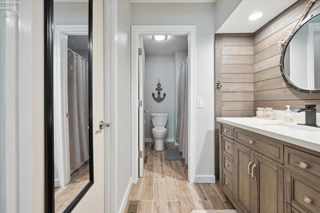 bathroom featuring vanity and toilet