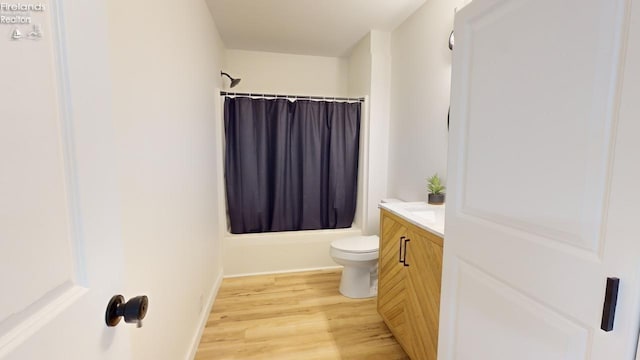 full bathroom with shower / bath combination with curtain, vanity, toilet, and hardwood / wood-style flooring