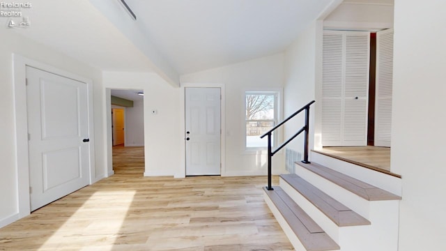 entrance foyer with light hardwood / wood-style flooring and vaulted ceiling