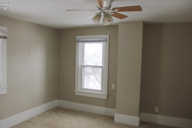 carpeted empty room featuring ceiling fan