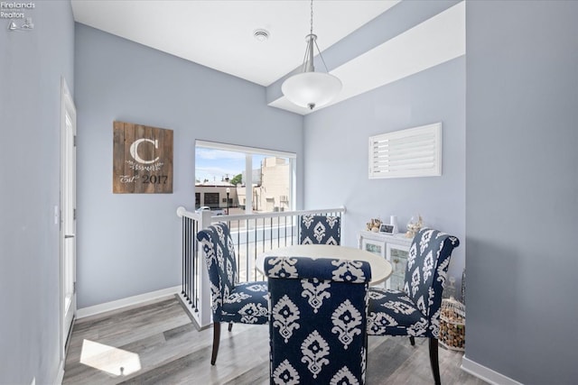 dining space with hardwood / wood-style floors