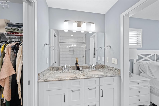 bathroom featuring vanity and a shower with shower door