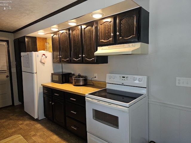 kitchen with crown molding, white appliances, and dark brown cabinets