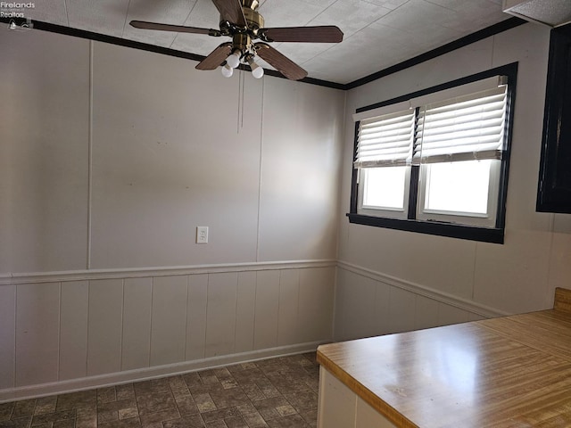 unfurnished room with crown molding and ceiling fan