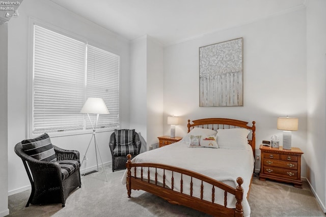 carpeted bedroom with ornamental molding