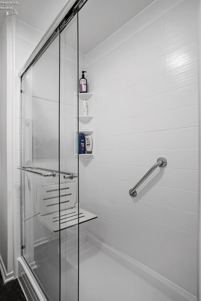 bathroom with a shower with door