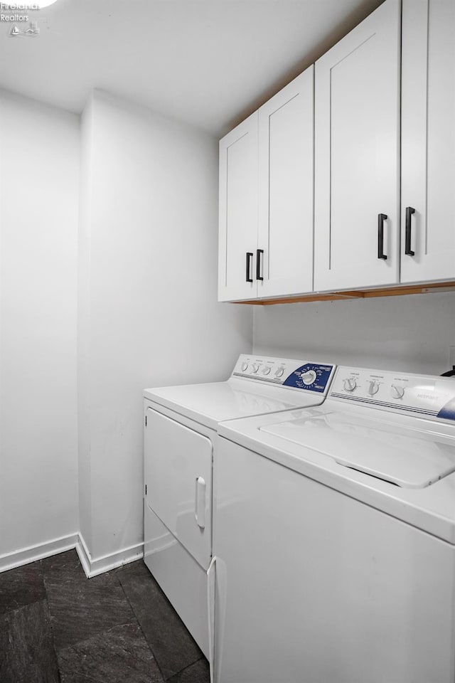 laundry room featuring cabinets and washing machine and clothes dryer