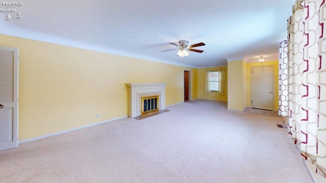 unfurnished living room featuring ceiling fan, light colored carpet, and a brick fireplace