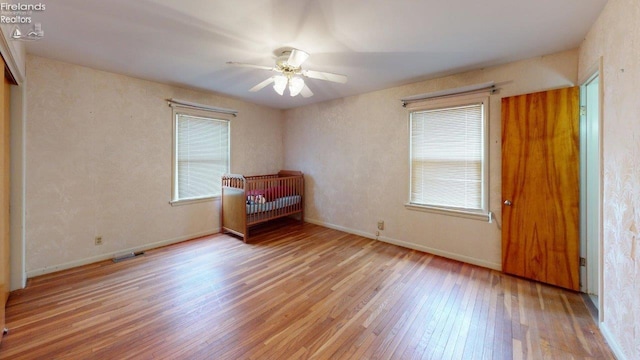 unfurnished bedroom featuring ceiling fan and light wood-type flooring