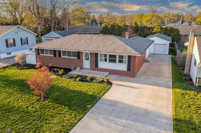 single story home featuring a garage, an outdoor structure, and a front yard