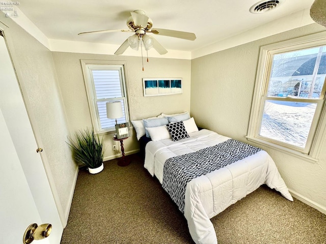 bedroom featuring dark carpet and ceiling fan