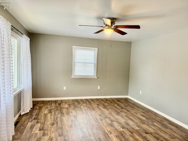 unfurnished bedroom featuring hardwood / wood-style flooring, ceiling fan, and multiple windows