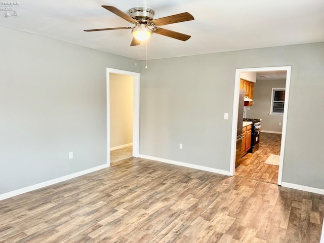 unfurnished room with ceiling fan and light hardwood / wood-style flooring