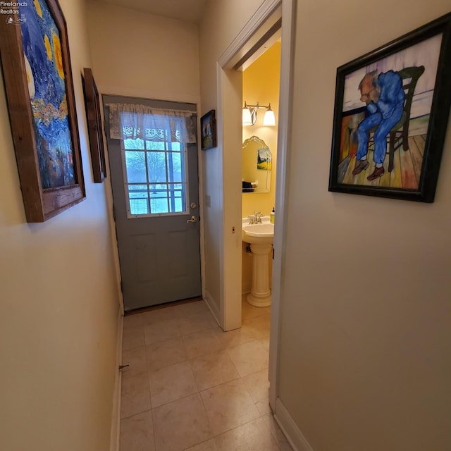 doorway featuring light tile patterned flooring