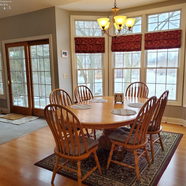 dining room featuring an inviting chandelier and wood-type flooring