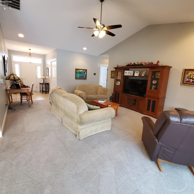 living room with vaulted ceiling, light carpet, and ceiling fan