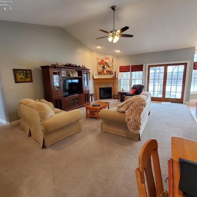 carpeted living room with lofted ceiling, french doors, and ceiling fan