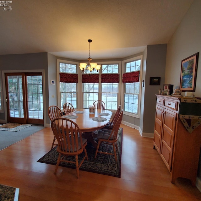 dining room featuring an inviting chandelier and light hardwood / wood-style flooring