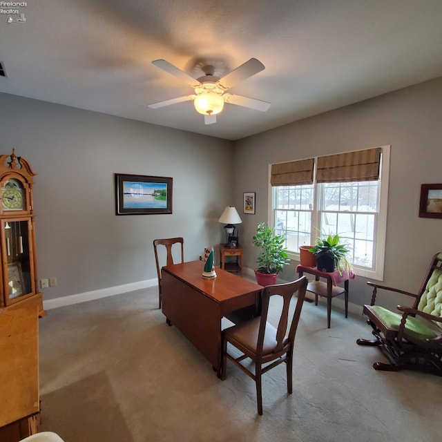 dining area featuring ceiling fan and light colored carpet