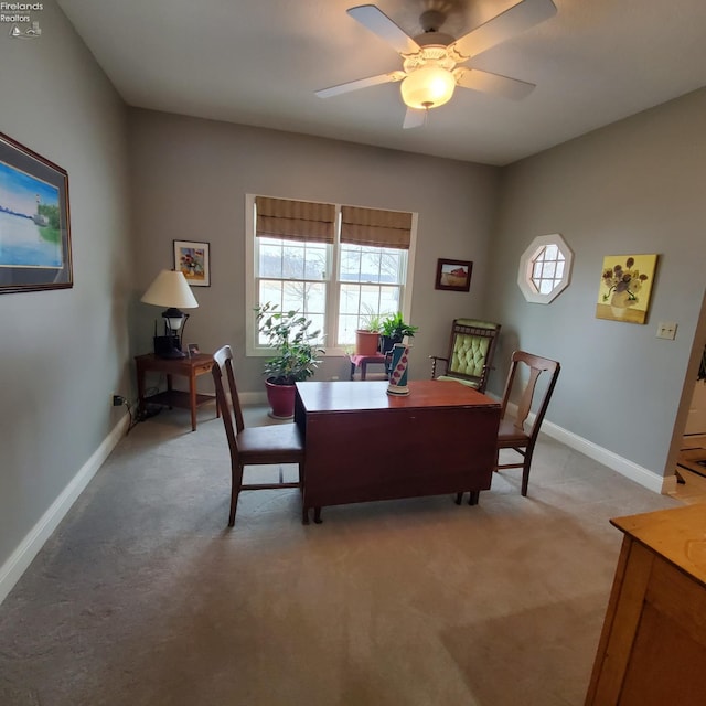 carpeted dining area with ceiling fan and a healthy amount of sunlight