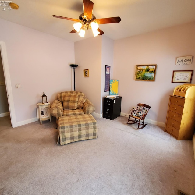 living area with carpet floors and ceiling fan