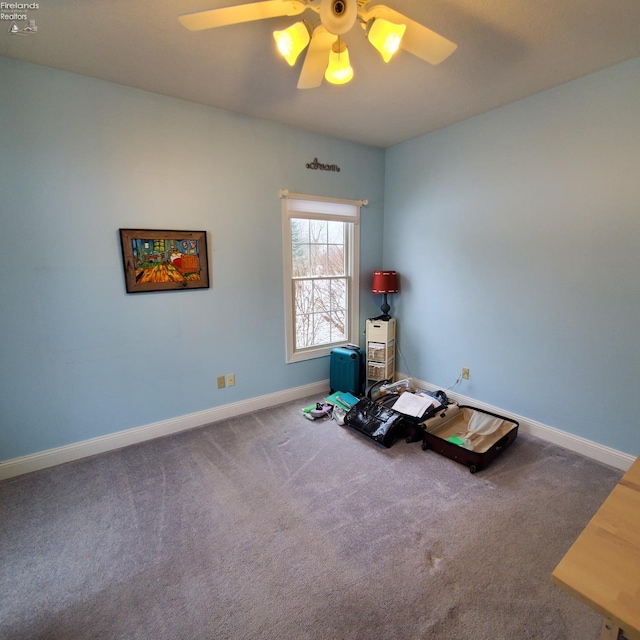 misc room with carpet flooring and ceiling fan