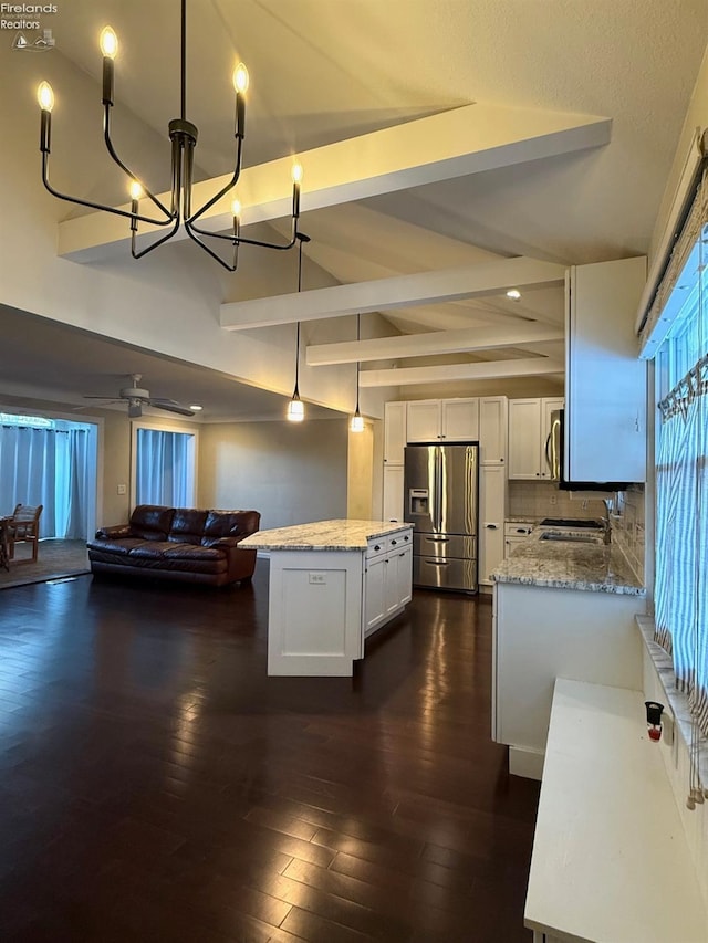 kitchen featuring decorative light fixtures, white cabinets, decorative backsplash, stainless steel appliances, and light stone countertops