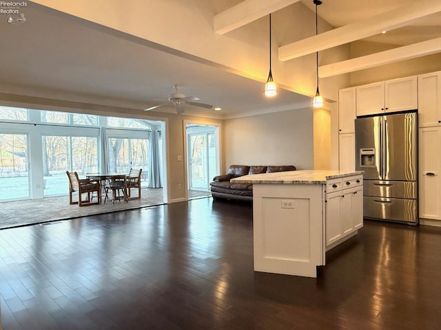 kitchen featuring white cabinetry, pendant lighting, light stone counters, and stainless steel fridge with ice dispenser