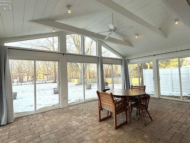 sunroom with lofted ceiling with beams and ceiling fan