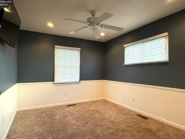 carpeted empty room with ceiling fan