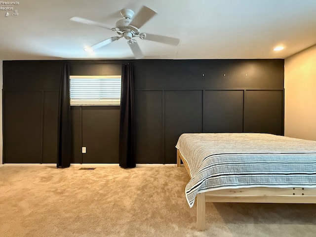 bedroom with light carpet and ceiling fan