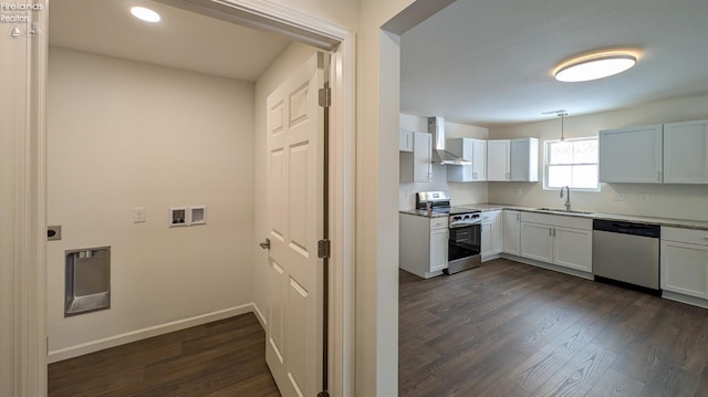 kitchen with stainless steel appliances, sink, white cabinets, and wall chimney exhaust hood