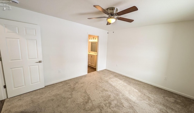 unfurnished bedroom featuring connected bathroom, ceiling fan, and carpet