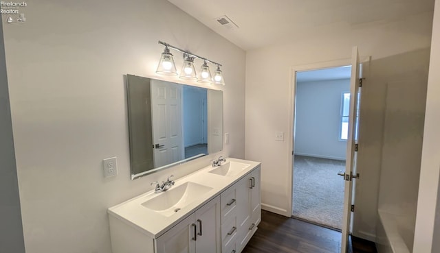 bathroom with vanity and hardwood / wood-style floors