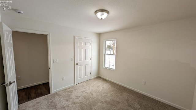 unfurnished bedroom with carpet floors and a closet