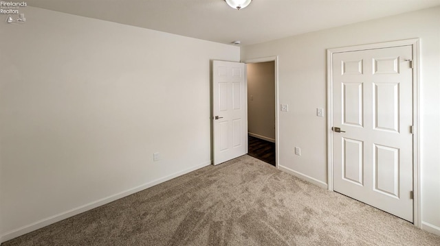 unfurnished bedroom featuring light carpet